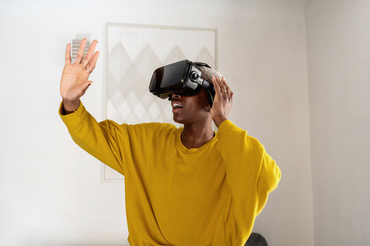 Amazed black gamer interacting with virtual reality