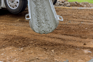Process of pouring cement on a new driveway for residential property in construction site