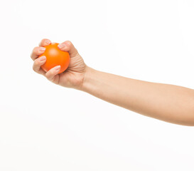 female hands holding an orange sponge ball on a white background isolated