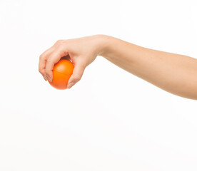 female hands holding an orange sponge ball on a white background isolated