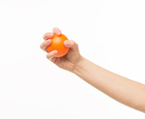 Fototapeta na wymiar female hands holding an orange sponge ball on a white background isolated