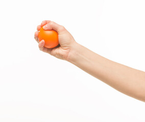 female hands holding an orange sponge ball on a white background isolated