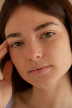 Young woman with freckles close up portrait