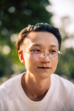 young Asian man with glasses. 
