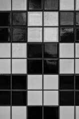 Closeup Photograph of Black and White Tiles in Groups of Four.