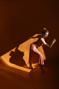 Graceful Woman Dancing In Sunny Studio