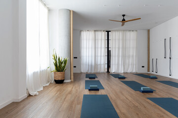 Spacious yoga studio with mats and blocks
