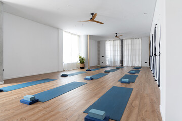 Spacious yoga studio with mats and blocks