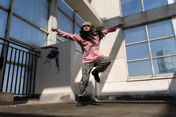 young woman hip hop dance on the roof