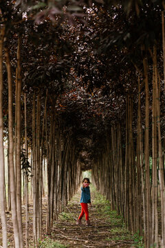 Girl in medical mask near trees