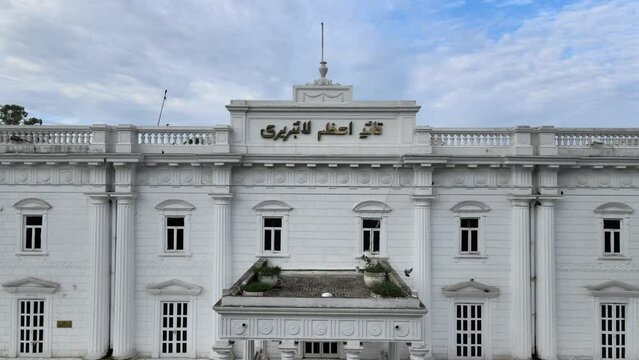 Quaid e Azam public Library and Jinnah Garden in Lahore - Aerial Video with rising drone and revealing the surrounding city. 