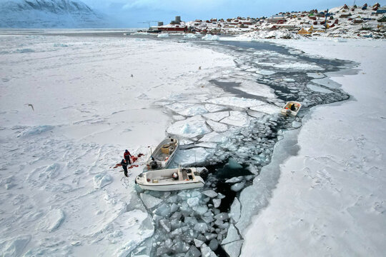 Greenlandic Inuit Inuk Eskimo hunters on Arctic sea ice, seal blood