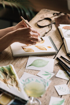 Hands Painting Leaves With Watercolours