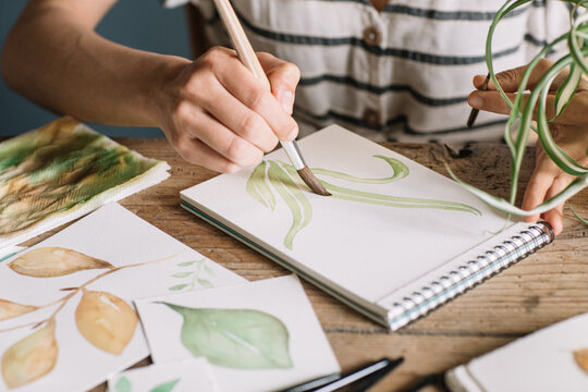 Hands Painting Leaves With Watercolours