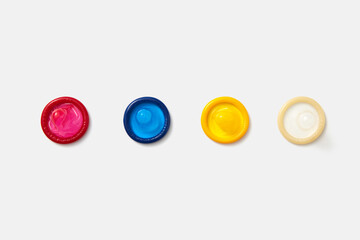 Colorful condoms on white background.
