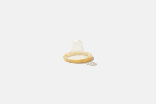 Single condom on white background.