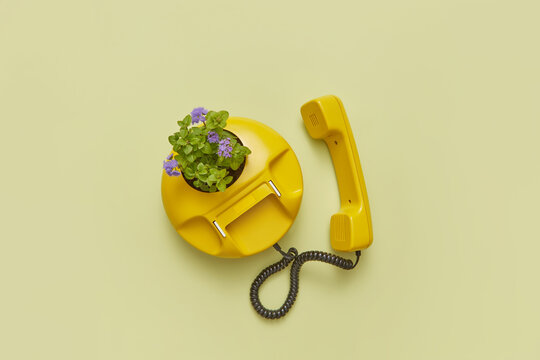 Vintage yellow telephone with flowers