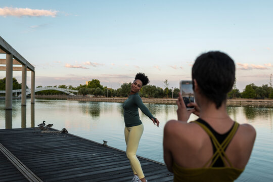 Multiracial women taking photo for social media