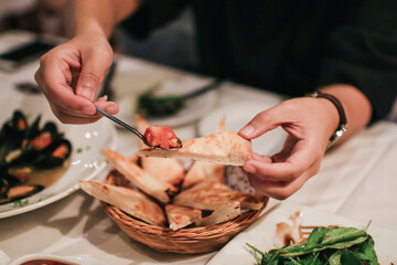Bread eat with chopped fresh tomato, olive oil flavored with garlic for appetizer. Italian and French food. Dinner table concept.
