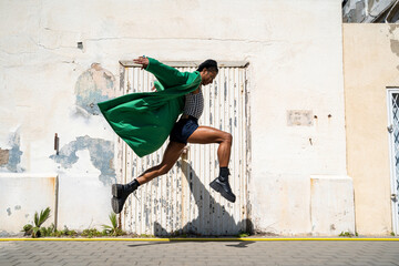man jumping with stylish look through the city