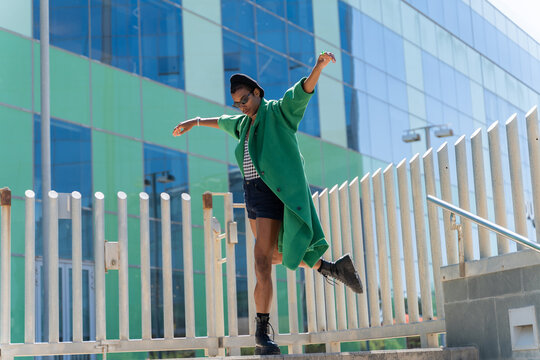 Stylish man dancing by the city