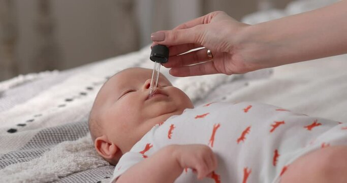 Every day the mother gives the child vitamins to strengthen the baby's immune system.