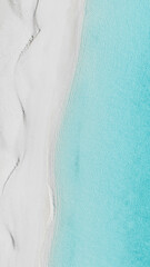 aerial photo split of beach meeting waves at concpetion island bahamas