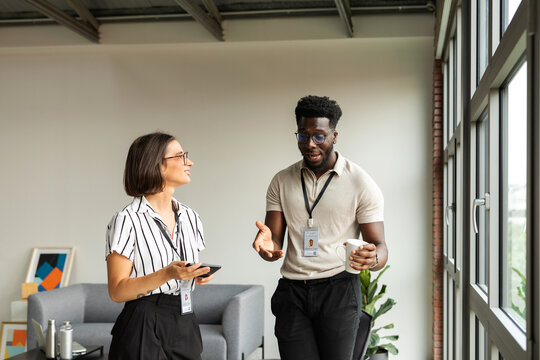 Mixed Business Couple Talking At Modern Office 