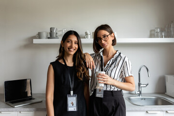 Two partners in office kitchen portrait