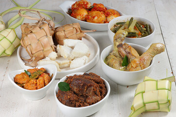 Ketupat Lebaran, served with sambal goreng, opor ayam, sayur labu siam, rendang and telur balado. Traditional celebratory menu during Eid al-Fitr and Eid al-Adha in Indonesia
