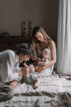 Parents Playing With Their Twins 