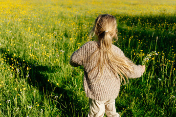 Anonymous child running in field