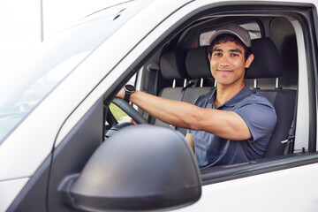 Young Hispanic courier driving van