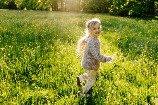 Happy child running away in field