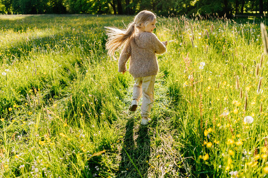 Merry girl running in field