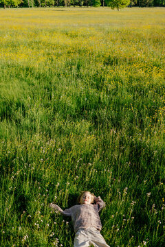 Child lying on blooming grass