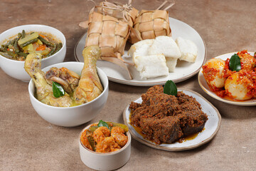 Ketupat Lebaran, served with sambal goreng, opor ayam, sayur labu siam, rendang and telur balado. Traditional celebratory menu during Eid al-Fitr and Eid al-Adha in Indonesia