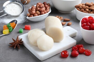 Marzipan and other ingredients for homemade Stollen on grey table. Baking traditional German Christmas bread