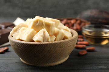 Organic cocoa butter on black wooden table, closeup