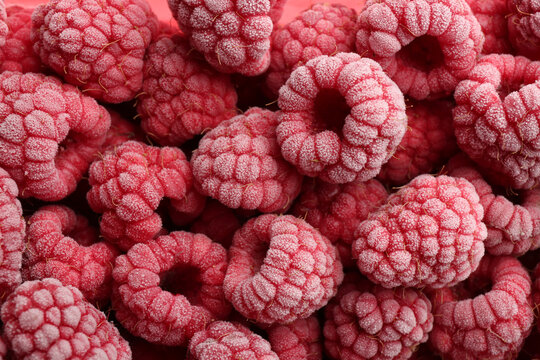 Tasty frozen raspberries as background, top view