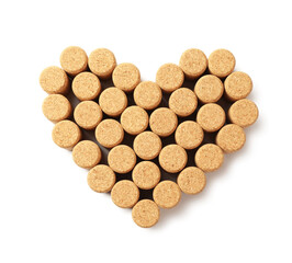 Heart made of wine bottle corks isolated on white, top view