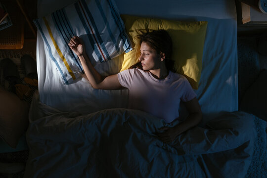 Woman sleeping in bed at night