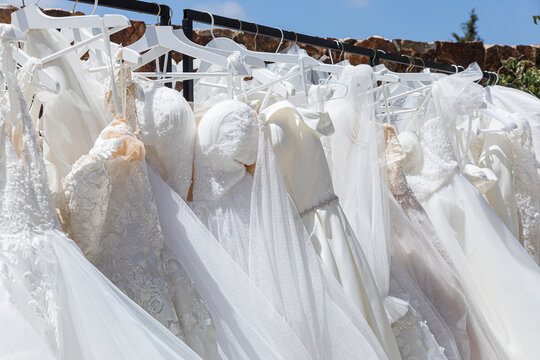 Rack with white wedding dresses
