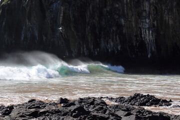 Waves hit Morro Dois Irmaos at Cacimba do Padre beach, Fernando de Noronha Island, Pernambuco,...