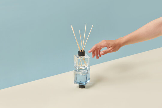 Female hand reaching out aroma diffusers.