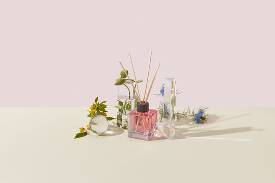 Glass aroma diffuser with beautiful garden flowers.