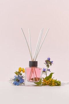Aroma diffuser with rattan sticks and garden flowers.