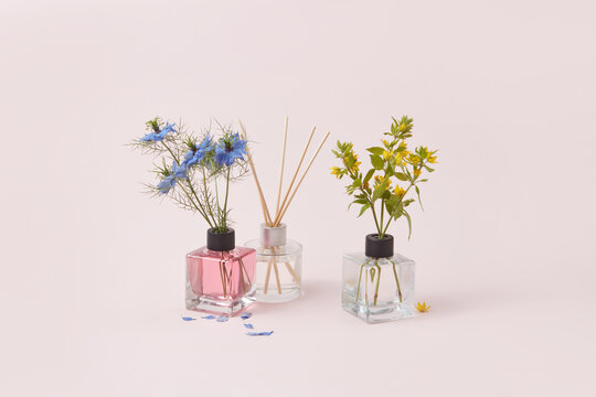 Glass aroma diffusers with garden flowers for decoration.