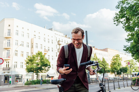 Man with Bicycle Using Mobile Phone