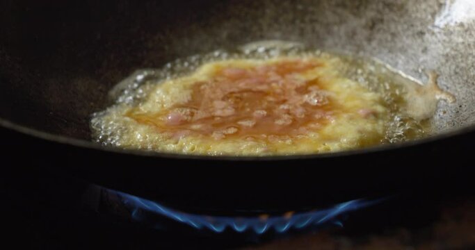 Close up process of cooking omelet in a hot pan.